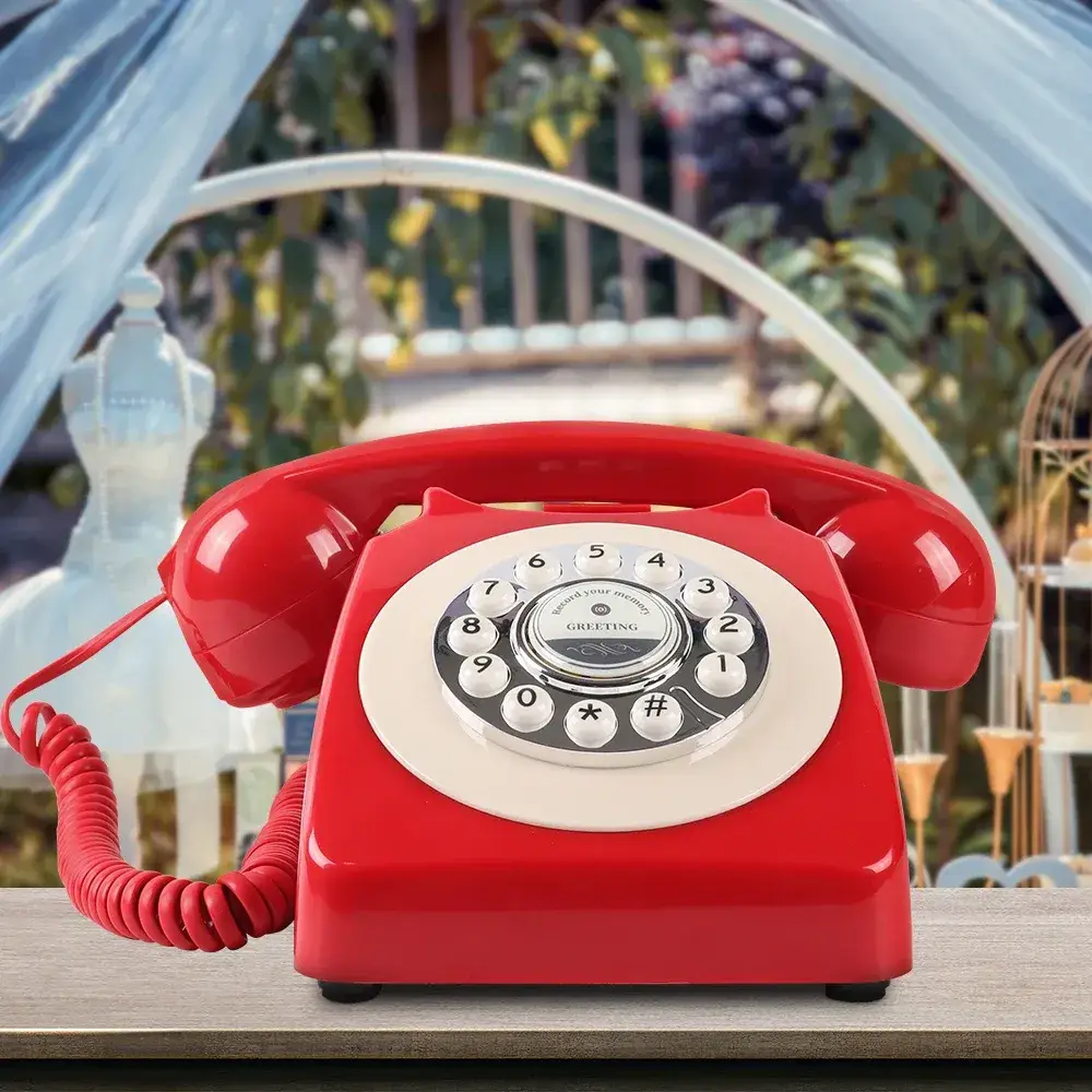 Red Classic50 Red retro telephone on a table, in front of a decorated wedding arch