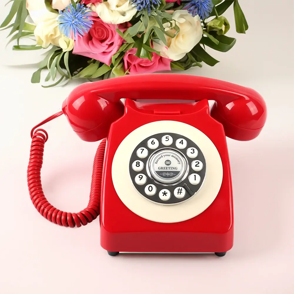 Red phone with a white keypad and a bouquet of flowers on top