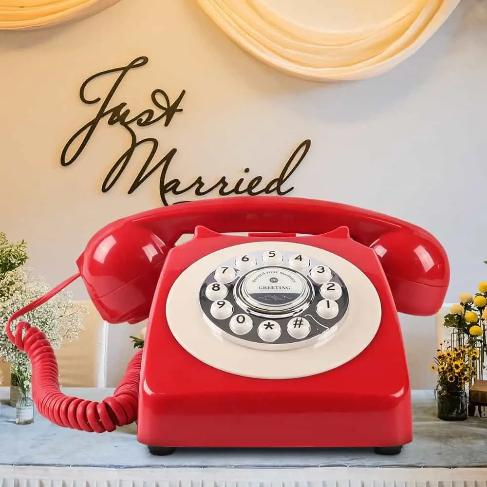 Red Classic50 Red retro telephone on a table, under a Just Married sign
