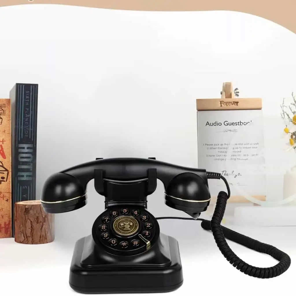 Чёрный ретро телефон Elegance70 Black рядом с книгами и табличкой с инструкцией